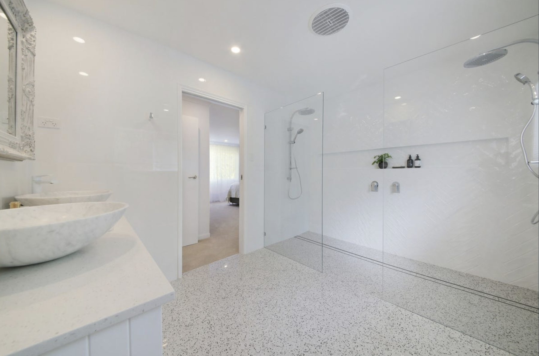 Restored bathroom with rendered walls and timber joinery by Forma Building